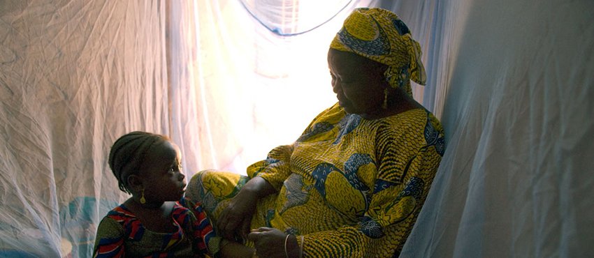 A family in Nigeria utilizes protective malaria bed nets. Photo: Arne Hoel/World Bank 