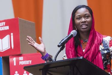 Woman on podium infront of SDGs