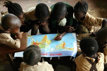 Children looking at a world map