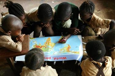 Children looking at a world map
