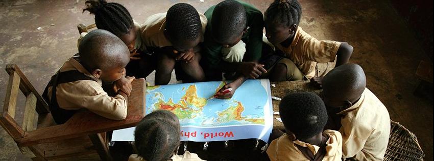 Children looking at a world map
