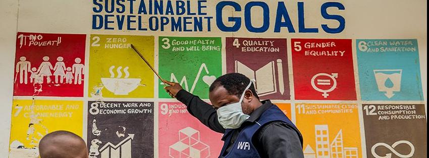 man pointing at SDGs