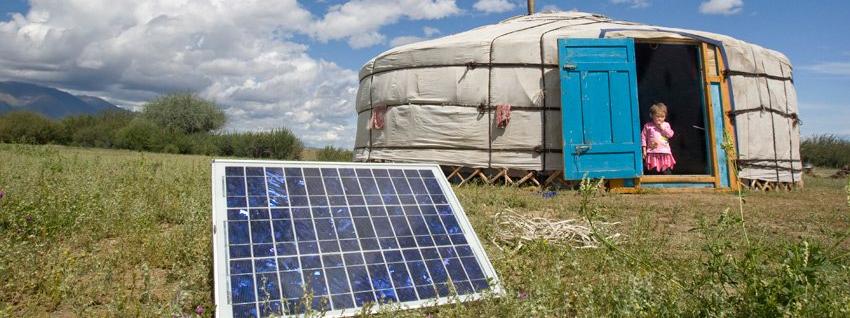 A family in Tarialan, Uvs Province, Mongolia, using a solar panel in 2009